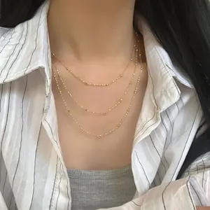 Dreilagige goldene Perlenhalskette für Damen mit minimalistischem Sternen-Lagen-Design