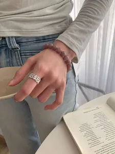 Detail von natürlichem lila Quarzperlenarmband und Vintage Silberring am Handgelenk