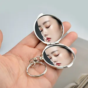 Mini silver metal folding double-sided makeup mirror with a round keychain hook ring
