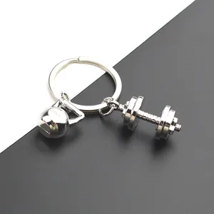 Metal dumbbell and kettlebell keychain accessory with silver polished finish for fitness fans