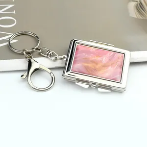 Macro view of silver rectangular keychain with pink marble texture and lobster clasp