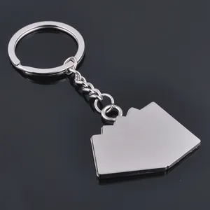 Polished silver metal poker keychain with geometric pendant on a reflective background