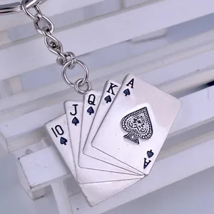 Macro view of silver poker cards pendant with spade suits and metal keyring