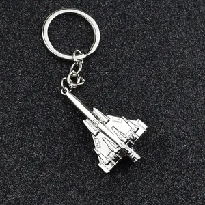 Silver F15 fighter jet metal keychain with detailed mechanical textures on dark background