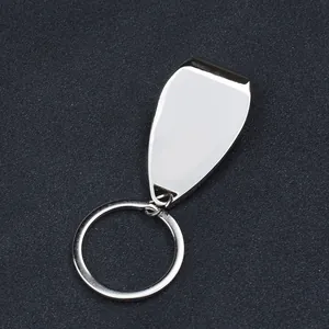 Detailed close-up of a polished metal bottle opener keychain on a textured background