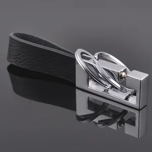 Premium black leather car keychain with silver metal rings on reflective background