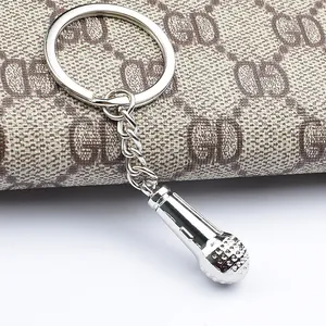 Detailed macro view of a silver microphone keychain with realistic mesh texture