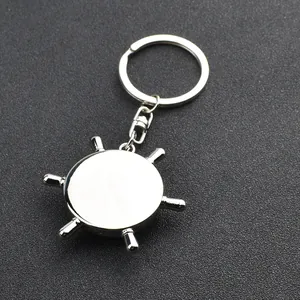Polished silver metal ship wheel keychain with customizable flat center for engraving