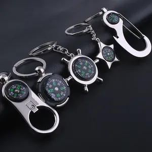Detail of silver and matte black metal compass keychains in various nautical shapes