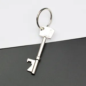 Creative key-shaped silver metal beer bottle opener with keyring on black and white background