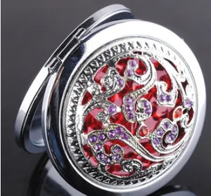 Detailed top view of a silver folding makeup mirror with intricate cutout patterns