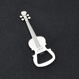 Macro shot of violin-shaped silver metal beer bottle opener on black texture