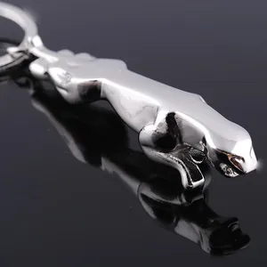 Detailed close-up of a silver jaguar car keychain with a high-polished mirror finish