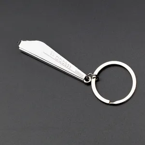 Macro detail of silver zinc alloy train keychain with polished finish and engraved textures