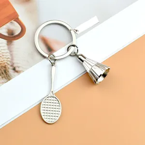 Detailaufnahme eines silbernen Badminton-Schlägers und Federball-Schlüsselanhängers in Silber
