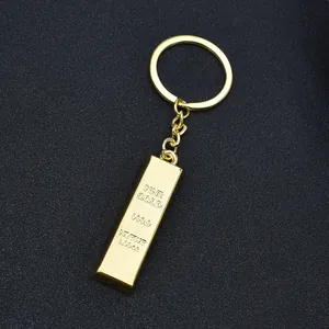 Macro shot of polished gold-plated bullion bar keychain featuring engraved 999.9 fine gold text