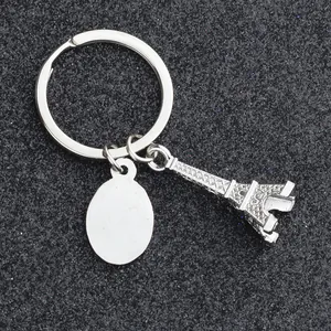 Detail of silver zinc alloy Eiffel Tower keychain with blank oval tag for engraving