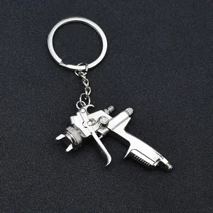 Polished silver metal keychain featuring a highly detailed miniature spray gun pendant