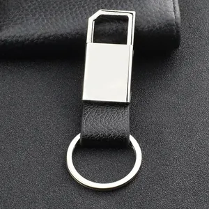 Classic leather and silver metal car keychain on a professional dark textured background