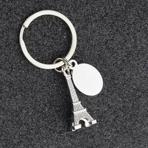 Close-up of silver zinc alloy Eiffel Tower keychain with blank oval pendant tag