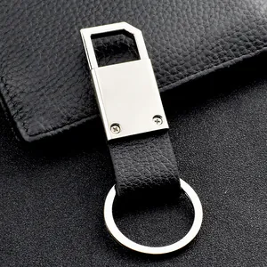 Close-up of black litchi grain leather car keychain with polished silver metal hardware