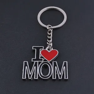 Polished metal keychain with I Love Mom pendant on a textured black background