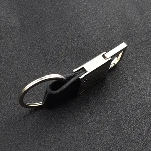 Close-up of silver metal clasp and black leather strap on a business keychain