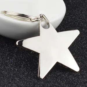 Close-up of a silver pentagram star keychain with a polished mirror finish and round ring