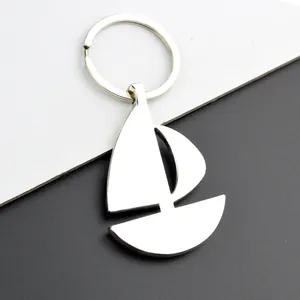 Polished silver metal sailboat keychain with minimalist design and round ring detail