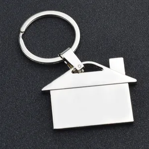 Detailed macro view of house-shaped silver metal keychain with polished flat surface