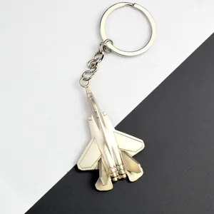 Close-up of a silver metal J-35A fighter jet keychain with detailed polished surface