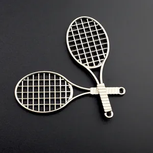 Close-up of silver metal tennis racket pendants with detailed mesh and textured grips