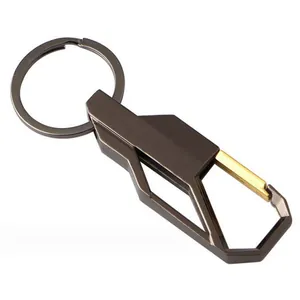 Detail of gunmetal grey car keychain with golden accent and carabiner clip