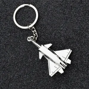 Macro view of fighter jet keychain with polished silver metal finish on black background