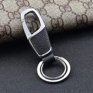 Macro detail of silver zinc alloy clasp and black leather trim for car key keychain