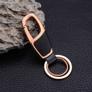 Premium leather car keychain with rose gold metal hook and rings on dark background