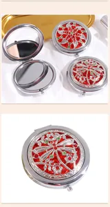 Macro detail of vintage silver compact mirror with dragonfly cut-out and red crystals