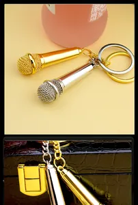 Detailed view of silver and gold microphone keychains with realistic mesh texture and ring
