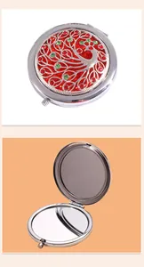 Macro view of silver folding makeup mirror with colorful peacock rhinestone inlay