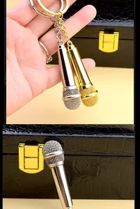 Macro view of silver and gold microphone keychains with realistic mesh texture