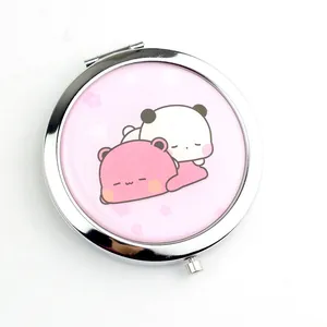Detail showing portable round makeup mirror with cute pink bear and panda design