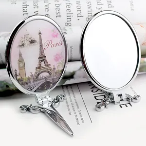 Vintage portable folding makeup mirror with Paris tower illustration and handle