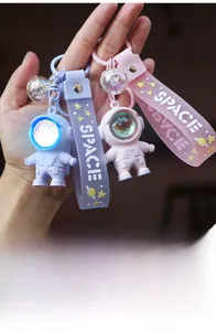 Glow-in-the-dark astronaut keychain accessory with a luminous space explorer design