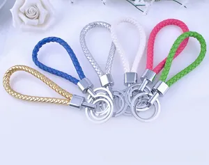 Detailed view of braided leather keychains in six vibrant metallic colors with silver rings