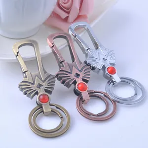 Detailed macro view of metal alloy vision keychains with red gemstones in three finishes