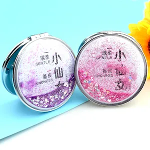 Detail of round quicksand makeup mirrors with purple sequins and silver metal frame