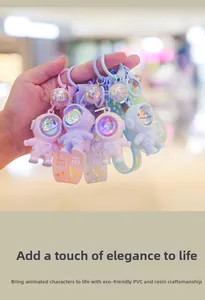 Close-up of colorful PVC astronaut keychains in soft macaron colors with hand strap