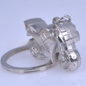 Detail view of a silver motorcycle-shaped metal keychain with a polished finish
