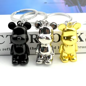 Metallic bear keychains in black, silver, and gold with elegant bow tie detail