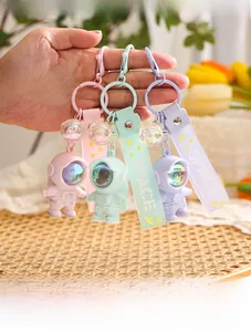 Detailed close-up of colorful astronaut keychains with silicone SPACE wrist straps